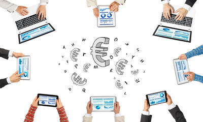 Fototapeta premium Top view of businesspeople sitting at table and using gadgets