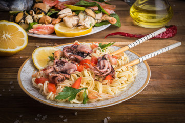 Noodles with seafood on a wooden background