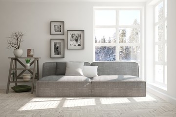 White room with sofa and winter landscape in window. Scandinavian interior design. 3D illustration © AntonSh