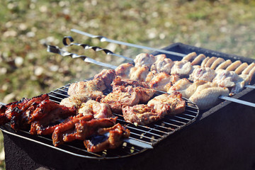 Grilled kebab cooking on metal skewer. Roasted meat cooked at barbecue. BBQ fresh beef meat chop slices.
