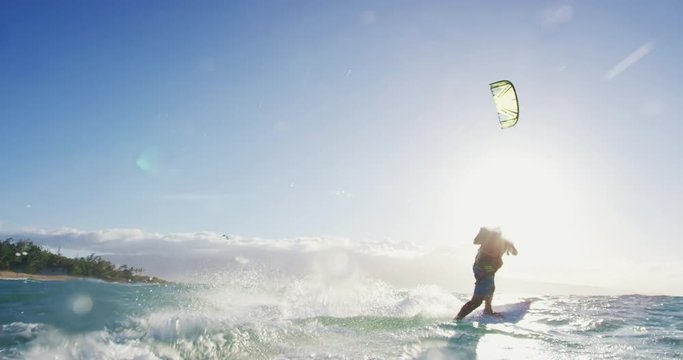 Young Man Kite Surfing on Surfboard at Sunset in Slow Motion