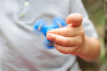 Boy playing with a Tri Fidget Hand Spinner