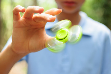 Boy playing with a Tri Fidget Hand Spinner