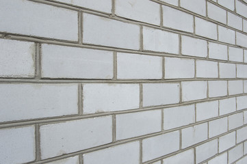 At an angle a wall of white brick