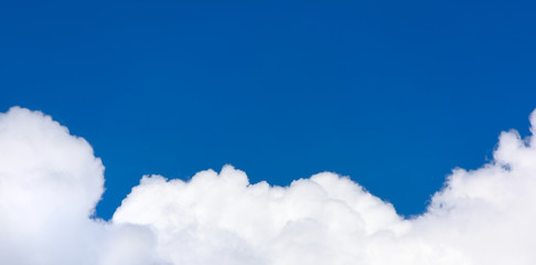 Naklejka na ściany i meble White and fluffy cloud on a blue sky close-up