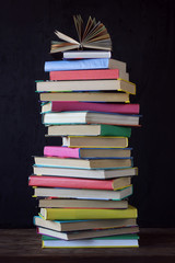 Stack of books on the background of the school Board.