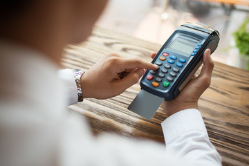 Close-up of man using payment terminal in shop