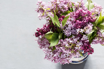 A bouquet of flowers of lilac on a gray concrete background.