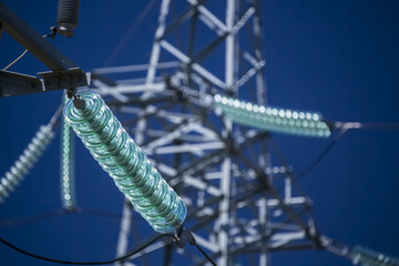High voltage transmission power tower with glass insulators - obrazy, fototapety, plakaty