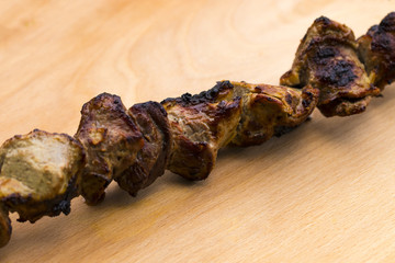 Pork shish kebab on a wooden table