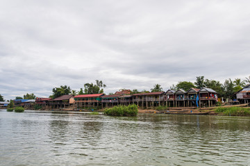 Fototapeta na wymiar Old wooden houses along the Mekong river in Laos, Dondet city.