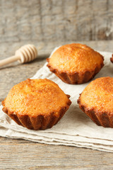 A few muffins in the baking dish. Wooden background.