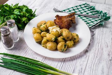 Fried pork chop, baked potatoes and fried young cabbage. Top view.