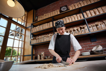 Woman cutting knead in restaurant