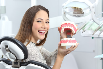 Dentist patient smiling with a plastic denture