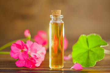 Essence of flowers on table in beautiful glass jar