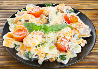 delicious delicious spaghetti with shrimps and basil on  plate