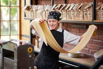 Woman rolling dough in cafe