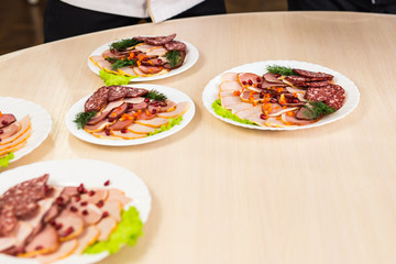 Dish with sliced meat products on the festive table