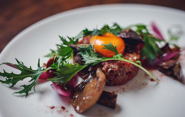 Healthy Beet Salad with fresh sweet baby spinach, kale lettuce, nuts, feta cheese and toast melted. Fresh salad with beets, closeup. Beetroot (beet) chopped for salad in bowl over rustic wooden table.