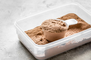 nutrition for workout with protein cocktail powder on stone background close up