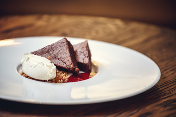 Slice of Plain New York Cheesecake on white plate on wooden background