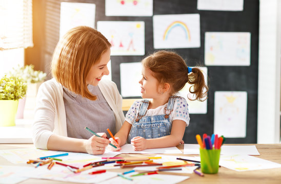 mother and child daughter draws in creativity in kindergarten