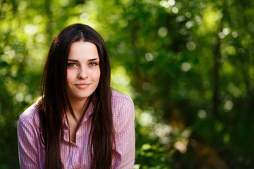 Fototapeta premium Young beautiful freckled green-eyed woman with healthy skin and light smile, cropped portrait