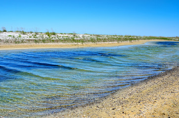 Blue water on the background of the desert sands.