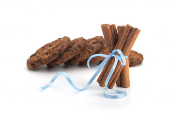 Festive wrapped cinnamon sticks isolated on white background