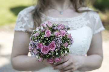 Wedding bouquet of flowers held by a bride. Pink, yellow and Green