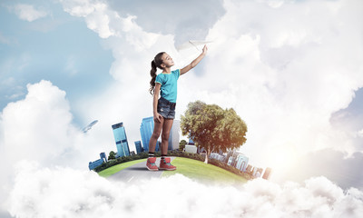 Concept of careless happy childhood with girl dreaming about fut