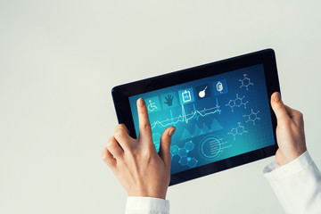 Close of female doctor hands working with tablet pc computer