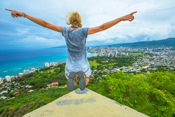 Happy hiker jumping. Hawaiian hiking by popular Diamond Head hike. Traveler freedom woman. Honolulu...