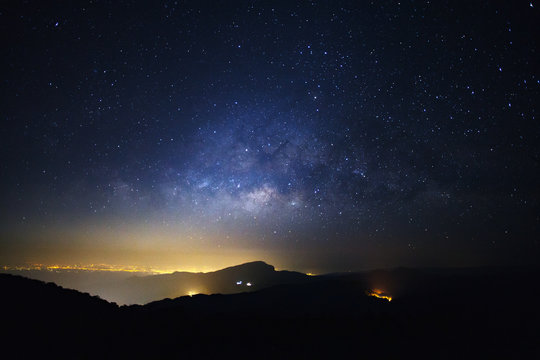 Milky Way Galaxy with light city at Doi inthanon Chiang mai, Thailand.Long exposure photograph.With grain