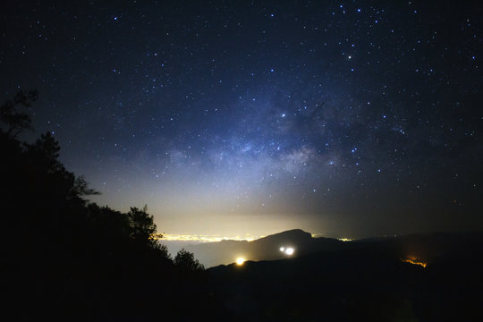 Milky Way Galaxy with light city at Doi inthanon Chiang mai, Thailand.Long exposure photograph.With grain
