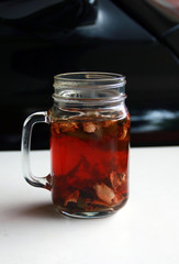 Wedang Uwuh, traditional herb drink from Jogjakarta, Indonesia. Contains a variety of leaves: cinnamon, nutmeg and cloves leaves. Another ingredient is wood from the secang tree, ginger and lump sugar