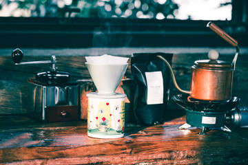 view of ground coffee pouring water on coffee ground with filter, wood background, Colour B&W Retro style