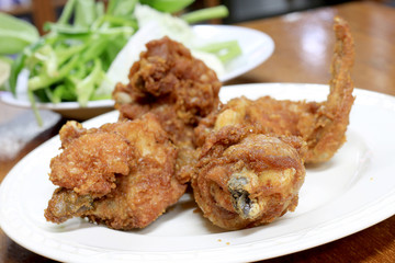 Spicy Deep Fried Breaded Chicken Wings in white dish on the table for dinner.