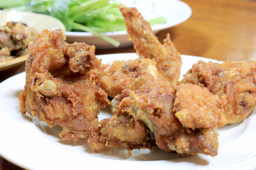 Spicy Deep Fried Breaded Chicken Wings in white dish on the table for dinner.
