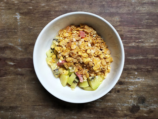cereal , fresh fruit and milk on the woonden table