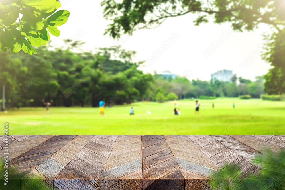 Aufkleber Empty grunge wooden plank table top with blur park green nature bokeh and leaf foreground,Mock up for display or montage of product