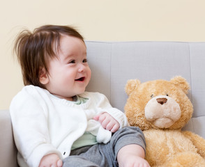 Happy baby boy with his teddy bear
