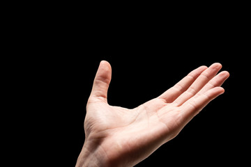 Male hand on a black background.
