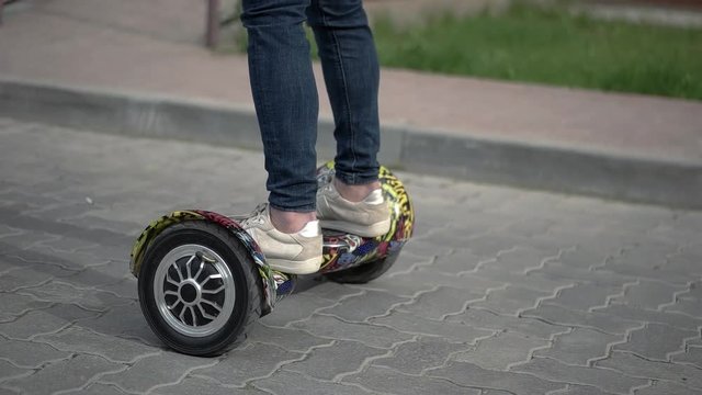 Riding Hoverboard or Electric Self Balancing Gyro Scooter Board on the Side Walk