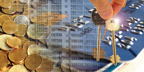 Keys from the house on the background of a credit card and money. The concept.