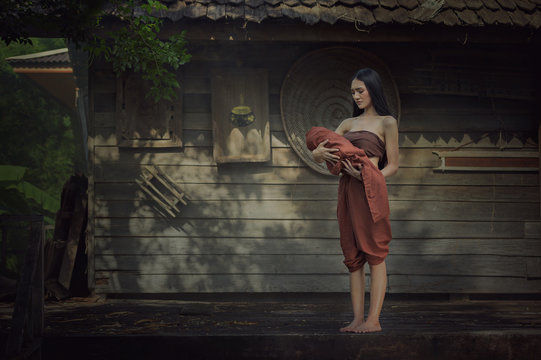 Legendary Thai ghost Mae Nak Phra Khanong,Mae Nak Phra Khanong stood carrying her baby,Thai Ghost concept,Thai traditional uniform dress.