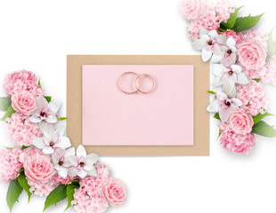 Obraz na płótnie Canvas Roses, magnolia, hortensia and bridal rings with paper greeting card for wedding
