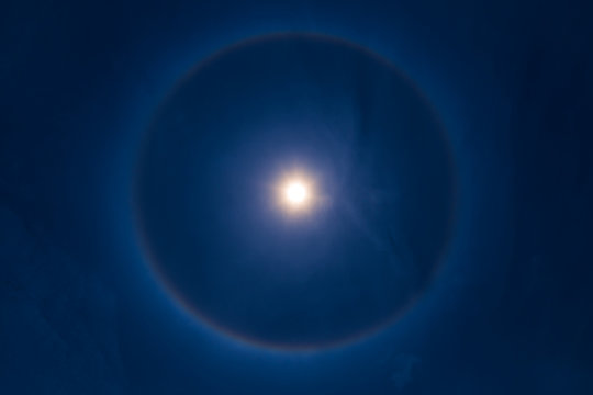 sky sun halo phenomenon in blue dark blue sky.
