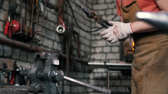 Blacksmith checks the symmetry of the knife blanks